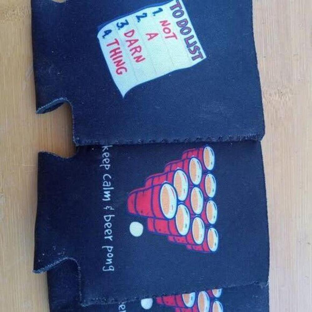 Set of three black neoprene can coolers.